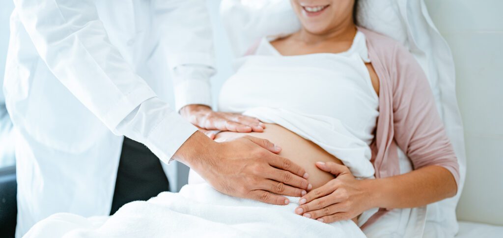 Doctor Examining Pregnant Patient During Prenatal Visit for Cord Blood Banking