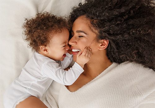 Happy Mom and Toddler Laughing Together