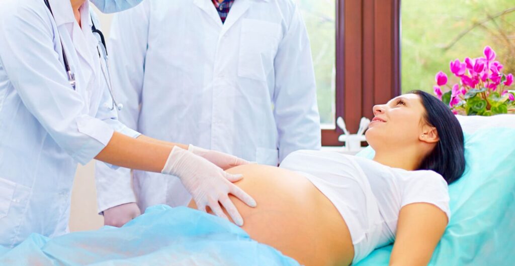 Medical Team Examining Pregnant Woman in Hospital Before Cord Blood Collection