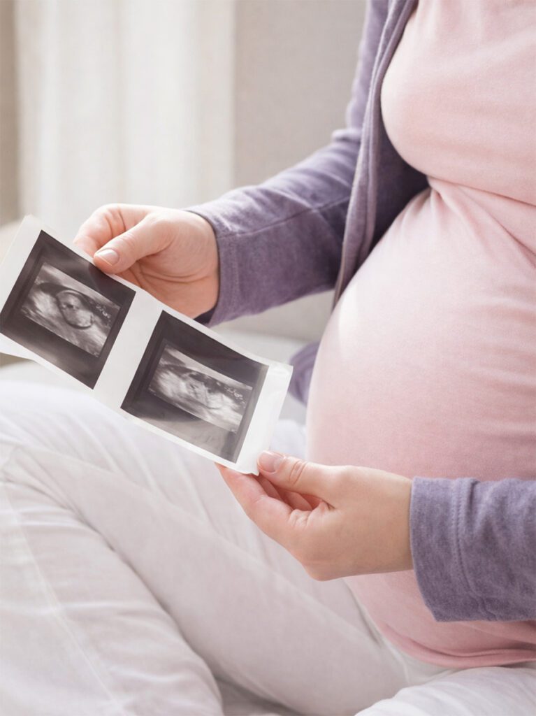 Pregnant Mother Reviewing Ultrasound Photos