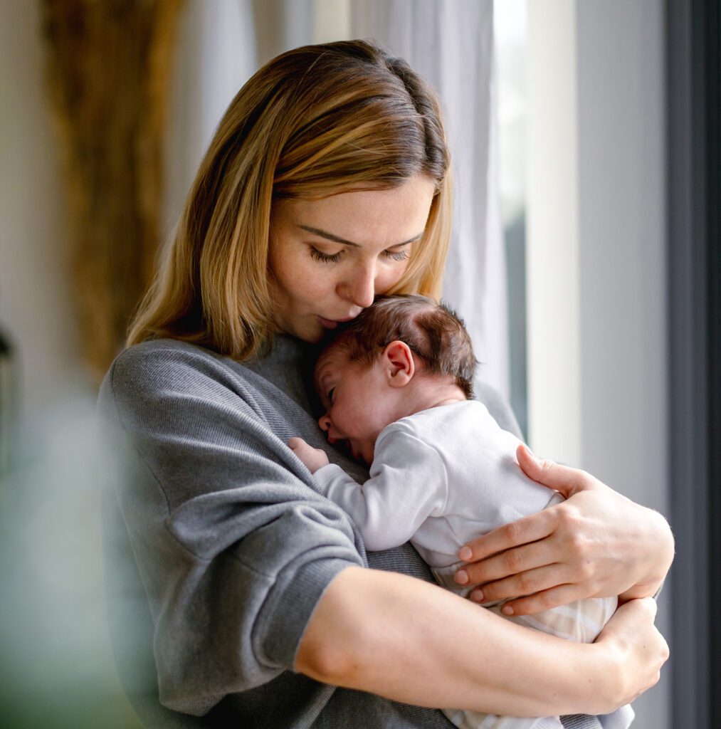 ew Mother Holding Newborn Baby After Cord Blood Banking with Miracle Cord