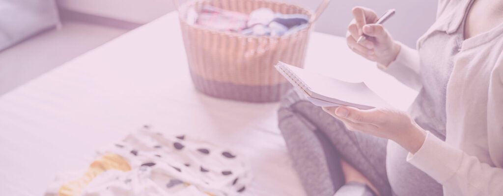 New parent writing down advice on a notebook.