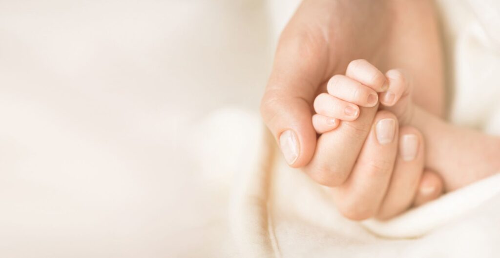 Newborn Baby Holding Parents Hand After Cord Tissue Banking
