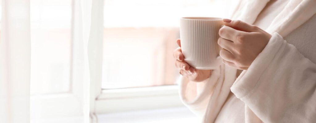 women holding a cup of tea